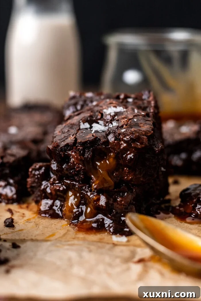 Stacked brown butter vegan caramel brownies with flaky sea salt