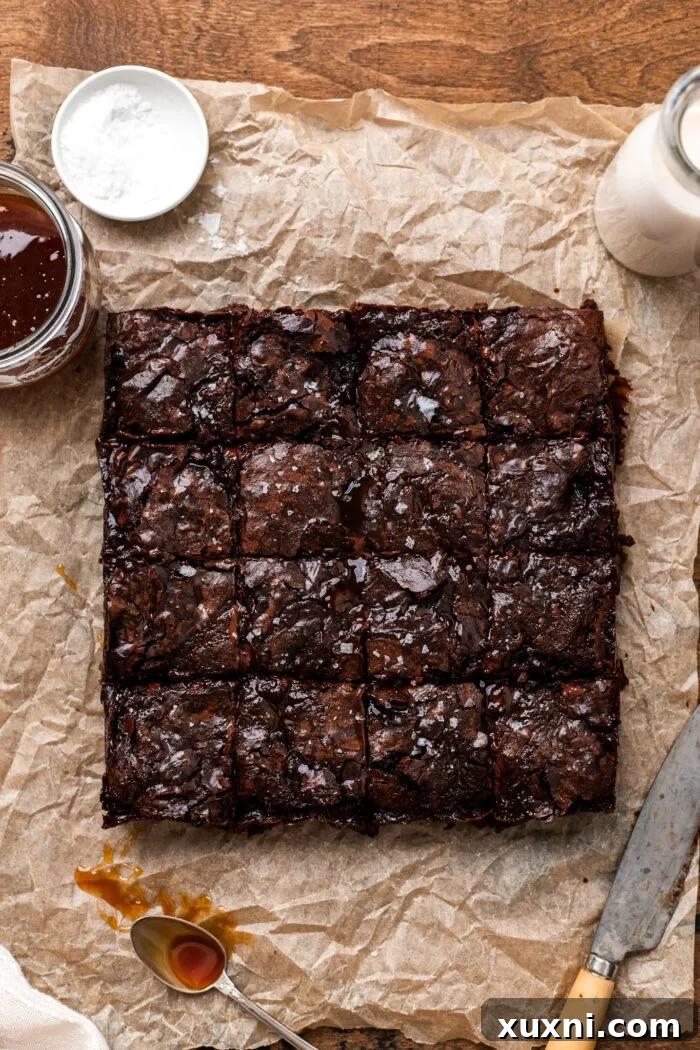 Sliced vegan salted caramel brownies garnished with flaky sea salt