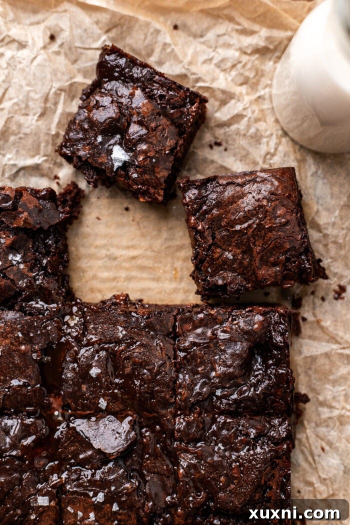 Close-up of a single perfectly sliced vegan caramel brownie with visible caramel layer