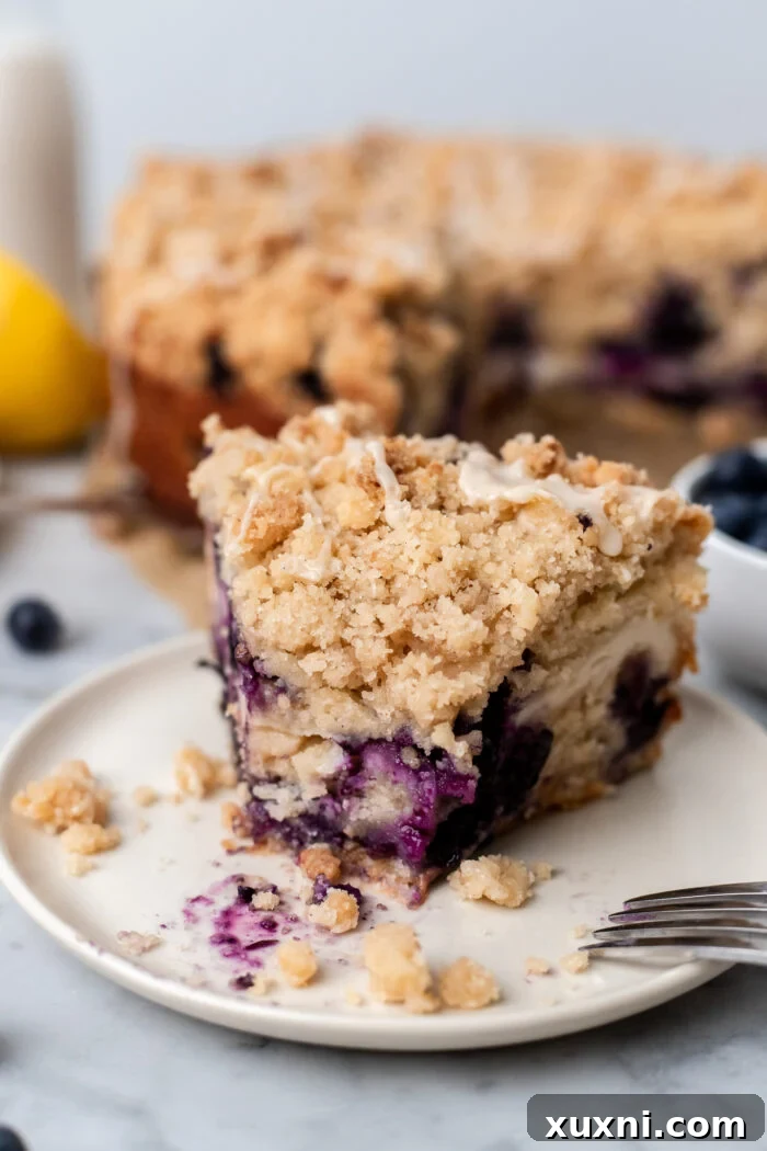 slice of vegan lemon blueberry coffee cake on a plate
