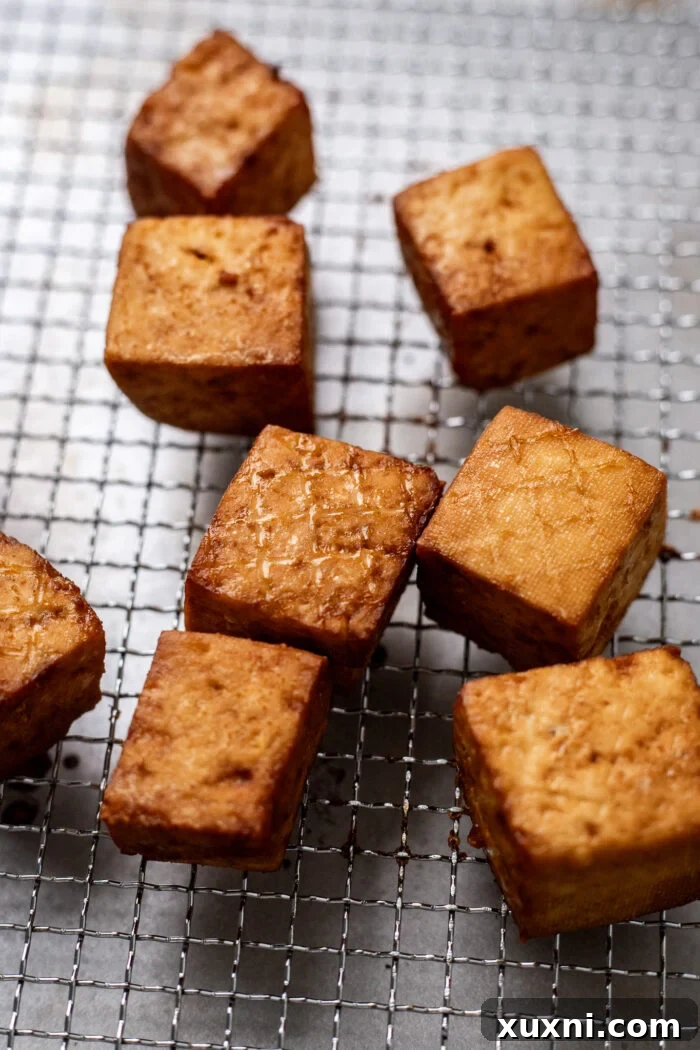 Perfectly crispy, golden-brown tofu after being cooked in an air fryer.