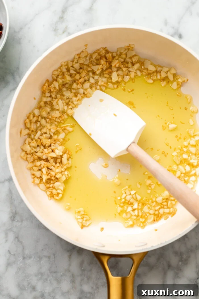 Lightly browned minced garlic simmering in olive oil, fragrant and golden.