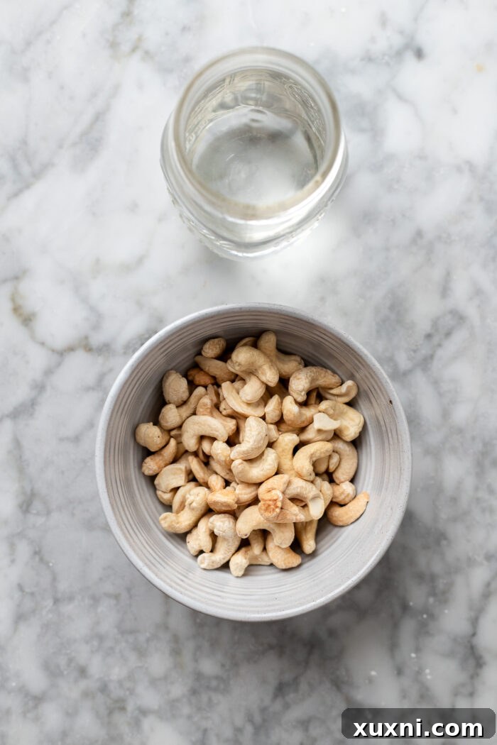 cashews and water on a marble table