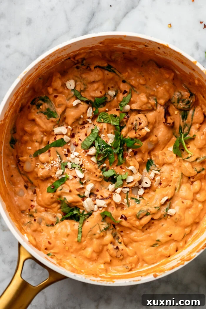 creamy garlicky butter beans in a sauce pan