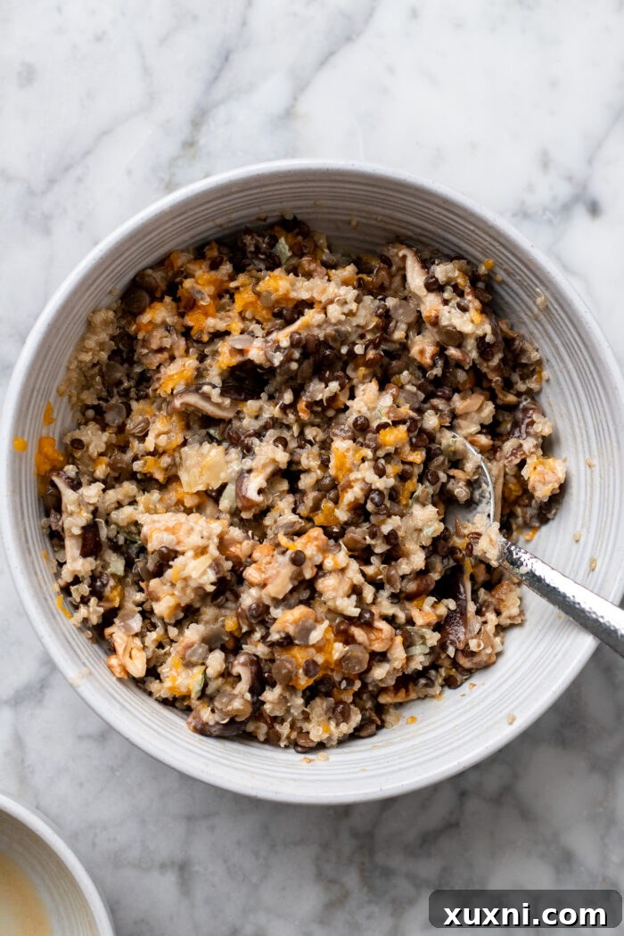 A bowl of the finished lentil quinoa stuffing mixture, vibrant and ready to fill the roasted butternut squash.