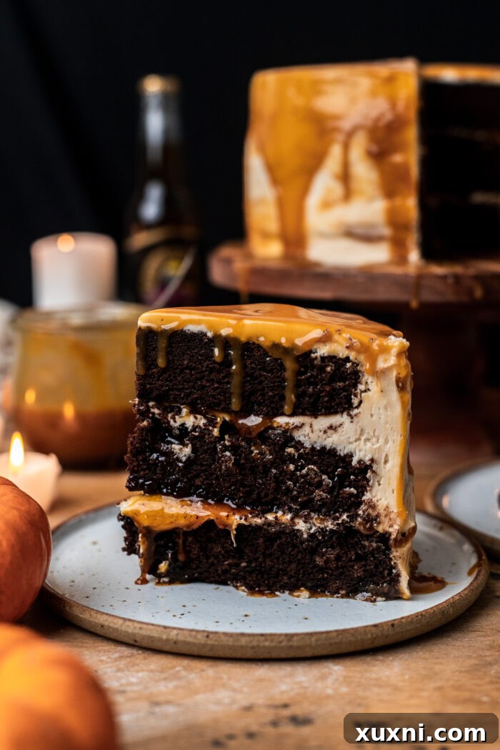 Slice of decadent vegan butterbeer chocolate cake on a plate, showcasing its layers and frosting.