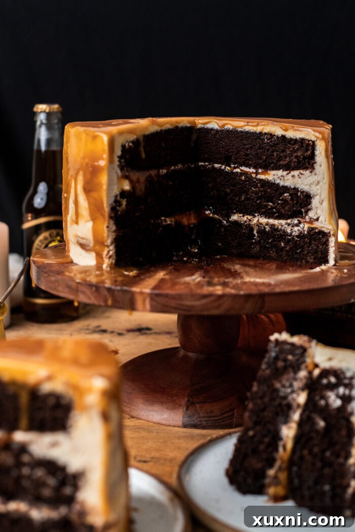 A beautifully frosted vegan butterbeer cake, showing the drizzle of butterscotch sauce on top and sides.