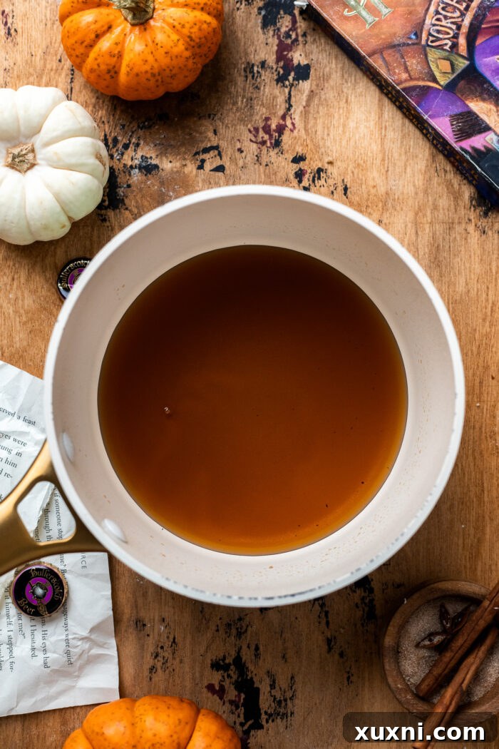 Butterbeer liquid simmering in a saucepan for reduction.