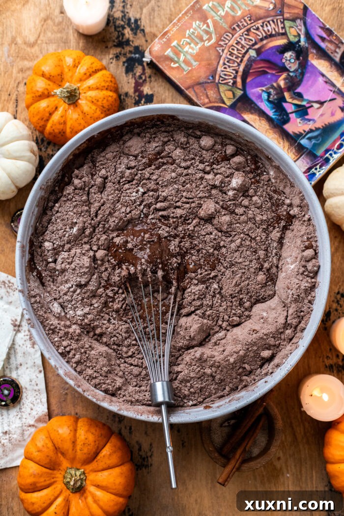 Dry ingredients being whisked into the wet ingredients for the chocolate butterbeer cake.