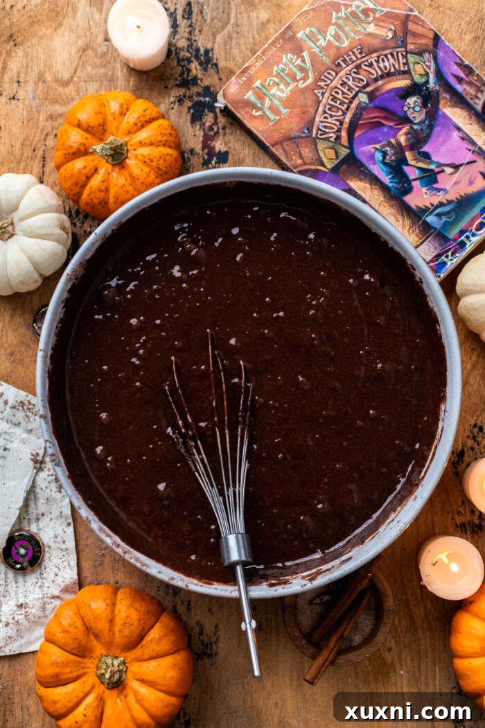 Adding vegan buttermilk, butterbeer reduction, and coffee mixture to the cake batter.