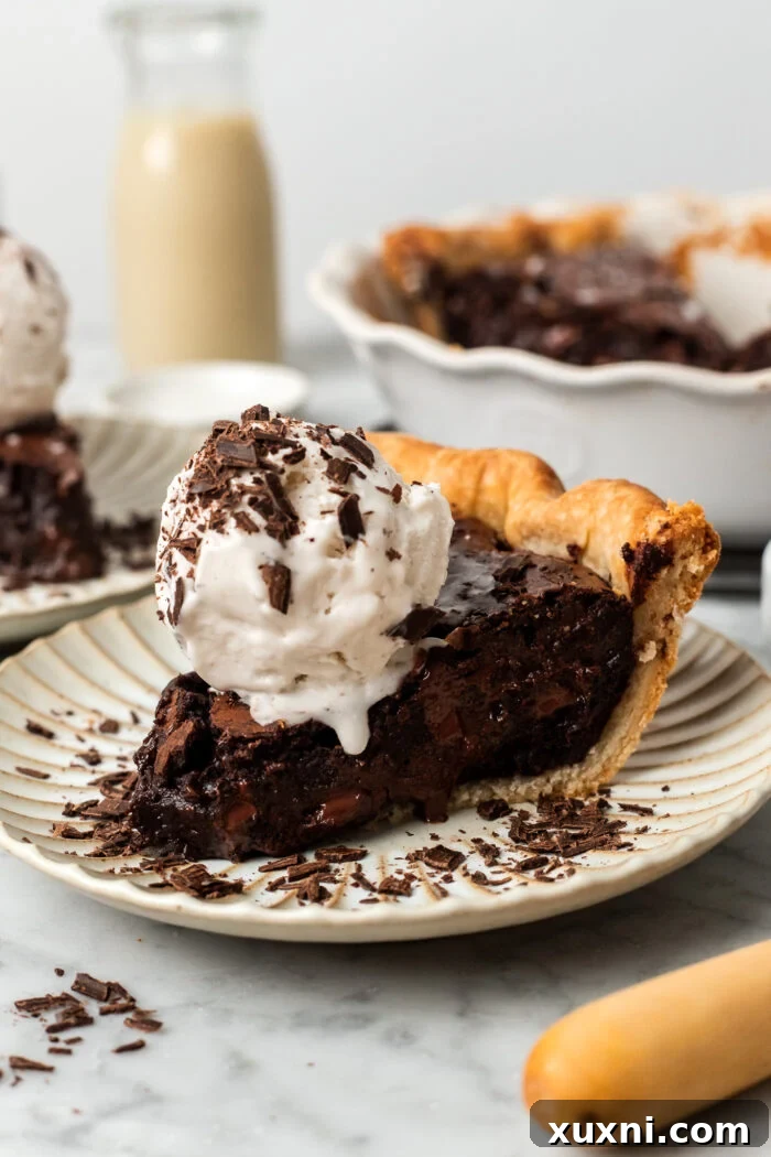 slice of vegan brownie pie with scoop of ice cream