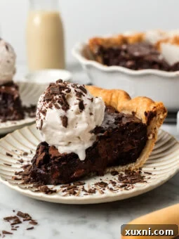 slice of vegan brownie pie with scoop of ice cream