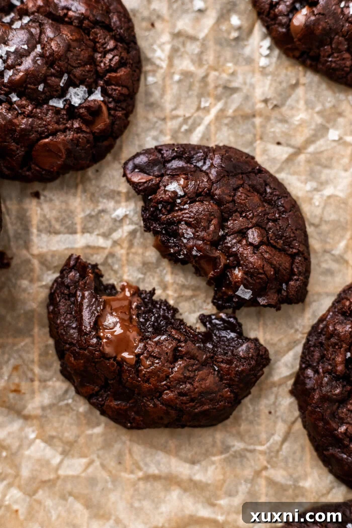 Effortless Fudgy Vegan Brownie Cookies 11 A broken open vegan brownie cookie revealing its fudgy interior