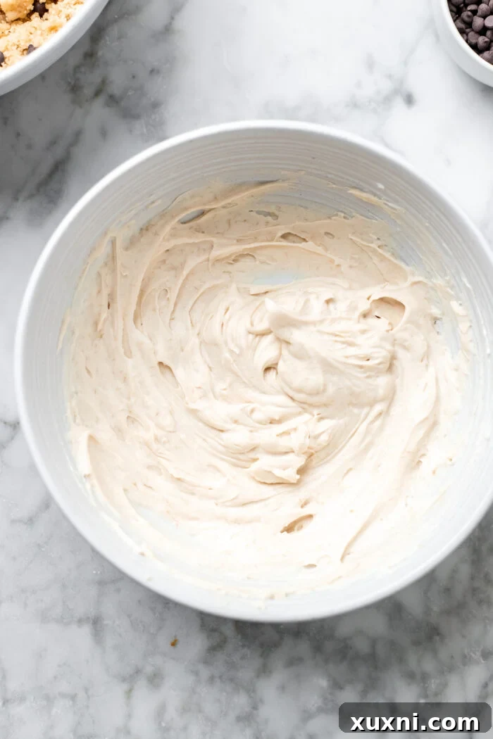 A creamy, smooth vegan cream cheese swirl mixture in a bowl, perfectly prepared to be layered into the coffee cake.