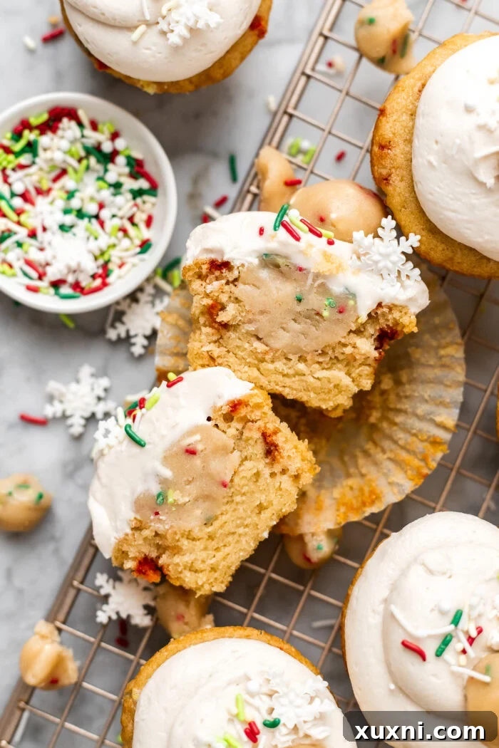 vegan cookie dough cupcakes sliced in half revealing the cookie dough center