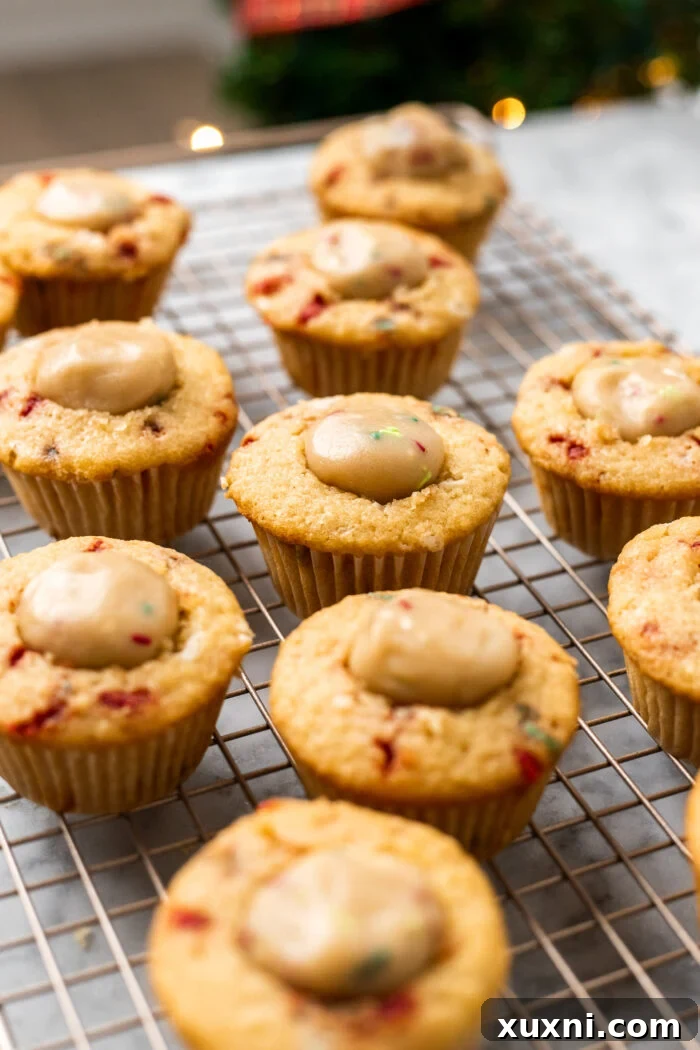 stuffed cookie dough cupcakes on a cooling rack after being filled