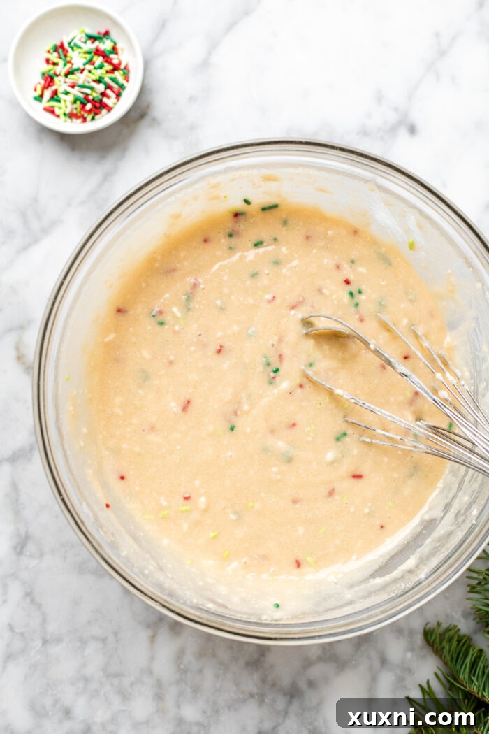 cupcake batter in a bowl with sprinkles