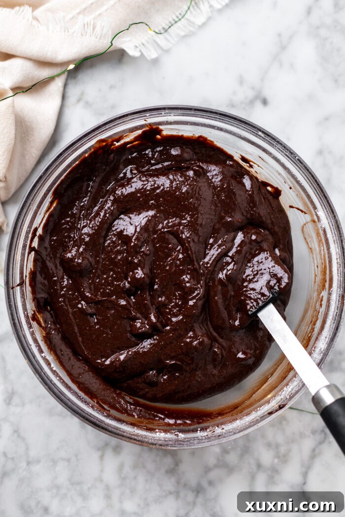 Brownie batter in a mixing bowl, ready to be divided.