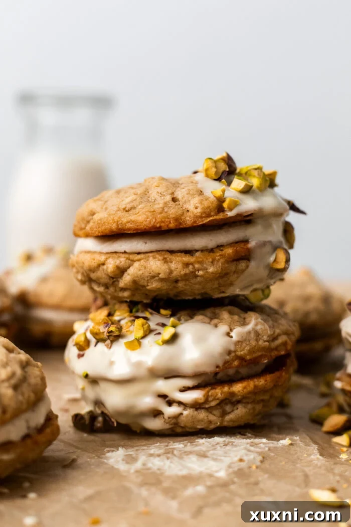 Easy Soft and Chewy Vegan Oatmeal Cream Pies 2 Stacked vegan oatmeal cream pies with creamy filling visible
