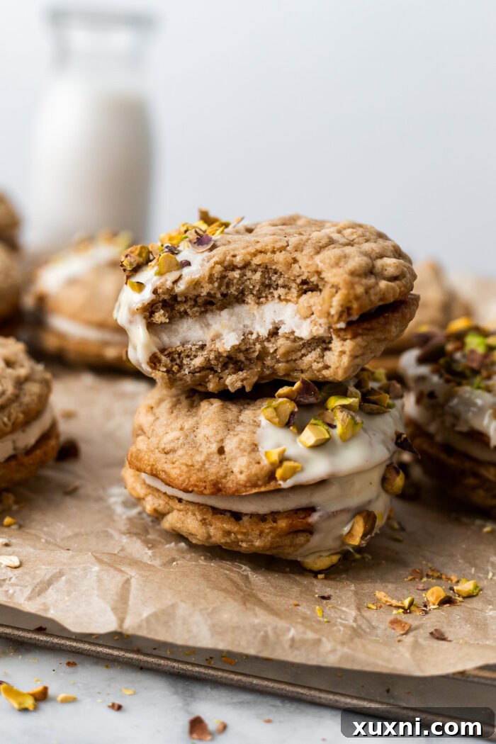 Easy Soft and Chewy Vegan Oatmeal Cream Pies 11 A stacked vegan oatmeal cream pie with a bite taken out, showing the creamy filling