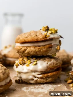Stacked vegan oatmeal cream pies with creamy filling visible