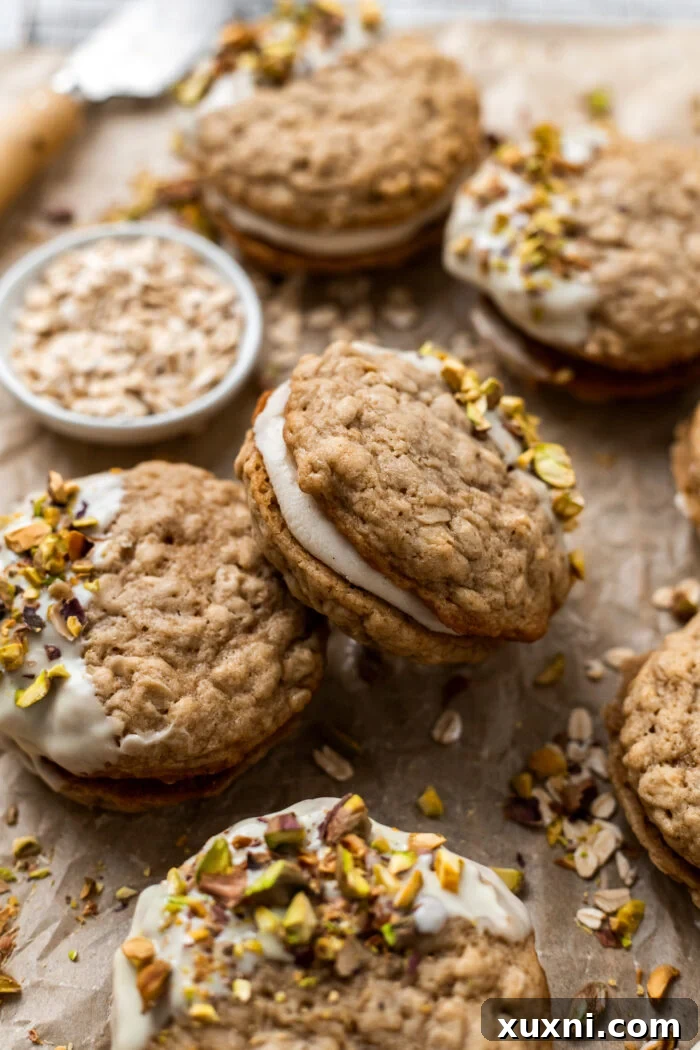 Easy Soft and Chewy Vegan Oatmeal Cream Pies 3 Vegan oatmeal cream pies cooling on parchment paper on a baking tray