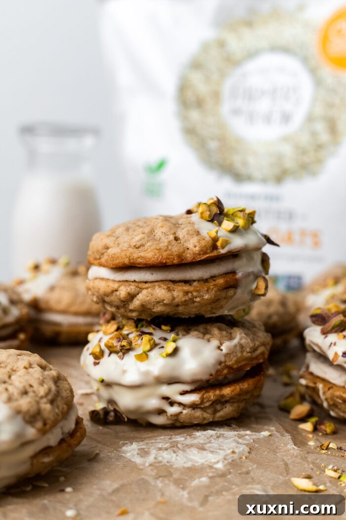 Easy Soft and Chewy Vegan Oatmeal Cream Pies 4 Stacked vegan oatmeal cream pies on a white stand
