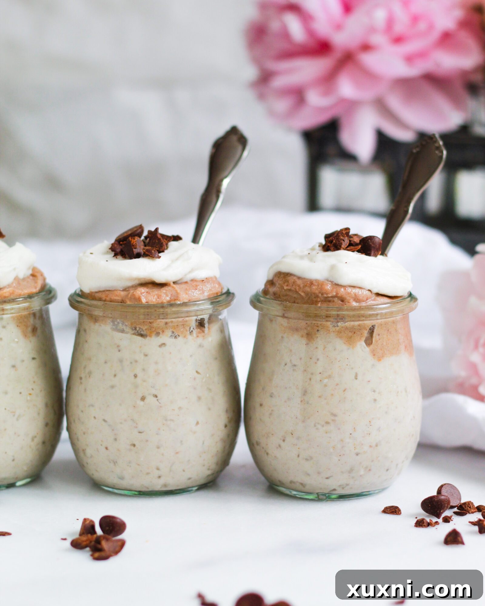 A charming arrangement of jars brimming with golden butterscotch pudding, highlighting its homemade goodness and appealing texture.