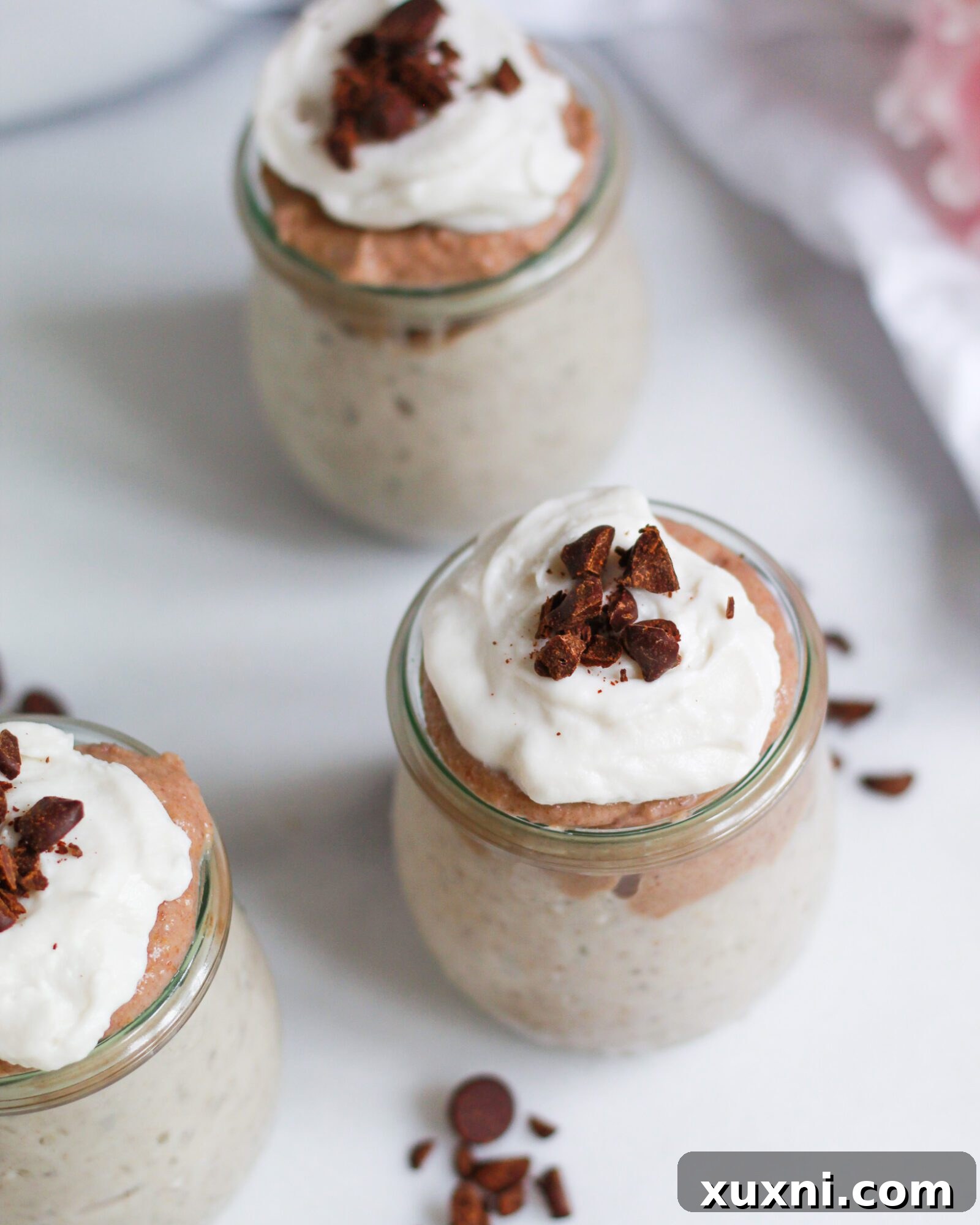 A three-quarter view of a bowl of creamy homemade vegan butterscotch pudding, inviting a closer look at its smooth consistency.