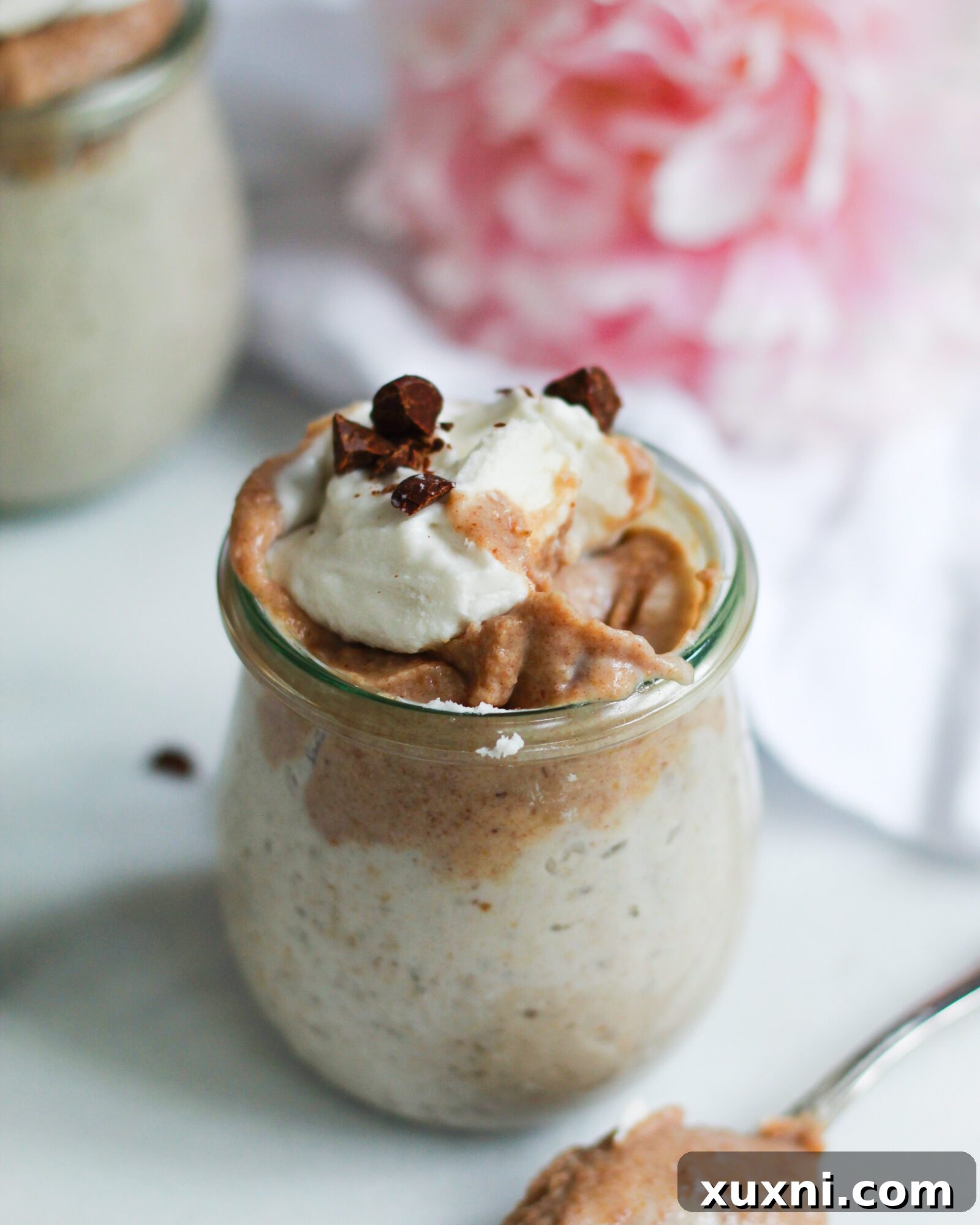 A charming close-up of a serving of vegan butterscotch pudding with a small bite taken out, showing its irresistible creaminess.