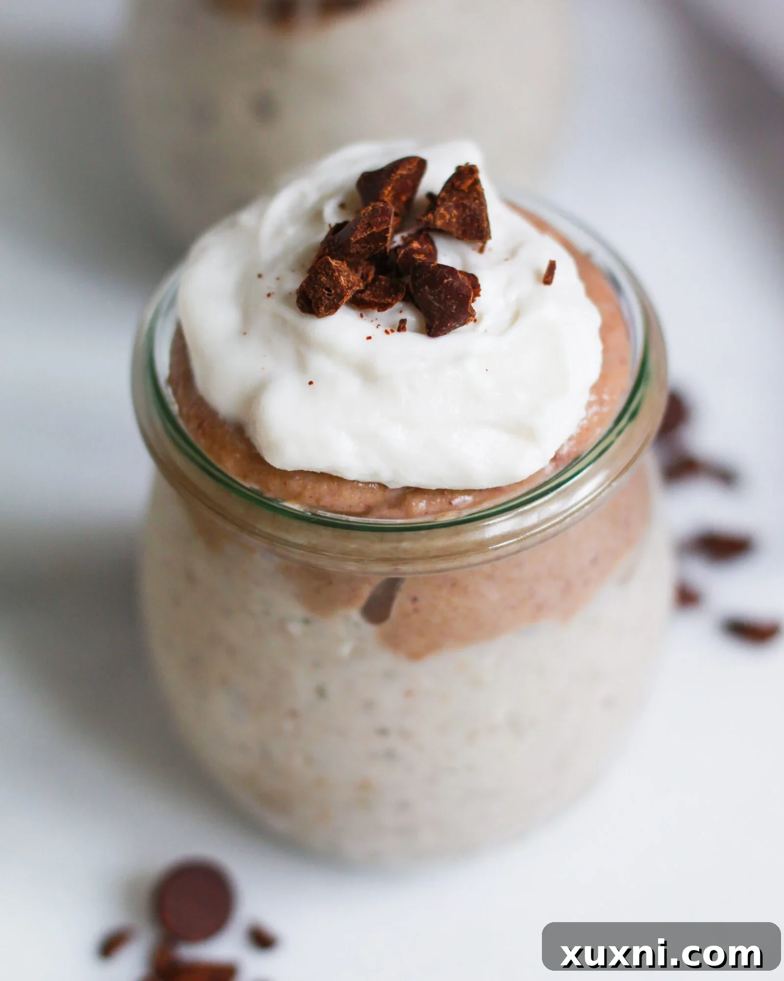 A luxurious close-up of vegan butterscotch pudding, revealing its smooth, golden texture and inviting creaminess in a serving dish.