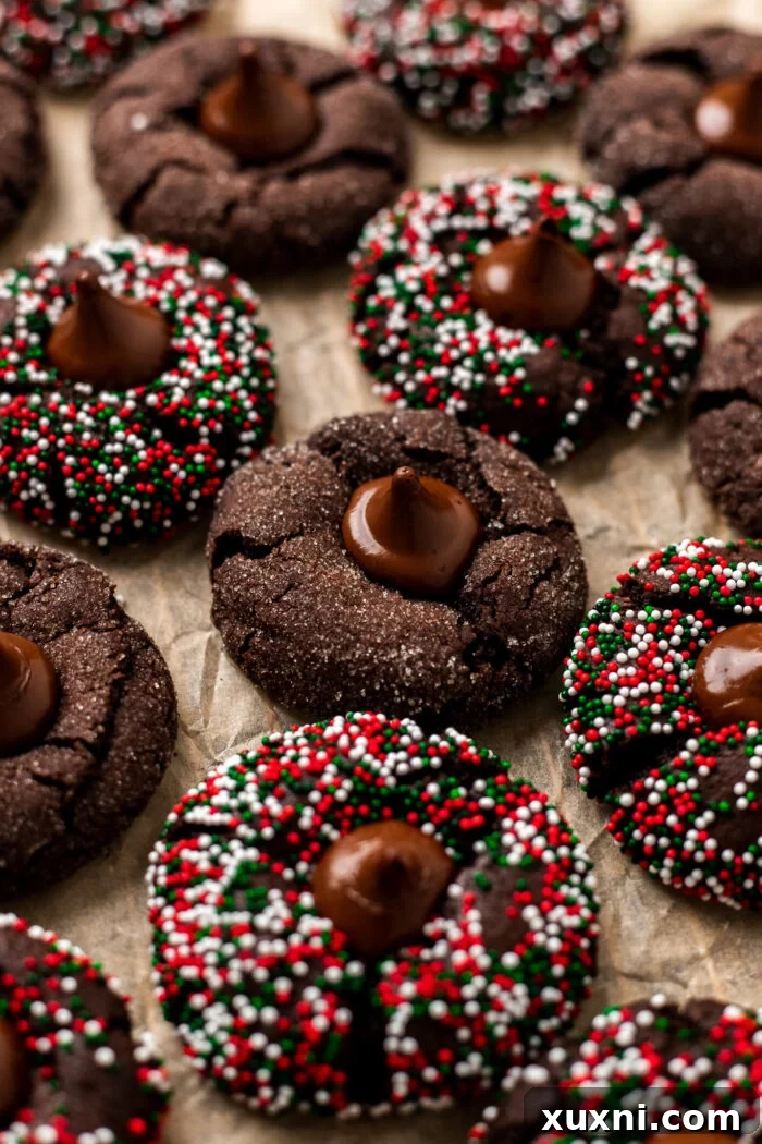 Several vegan chocolate blossoms neatly arranged on parchment paper, highlighting their perfect shape and chocolatey goodness.