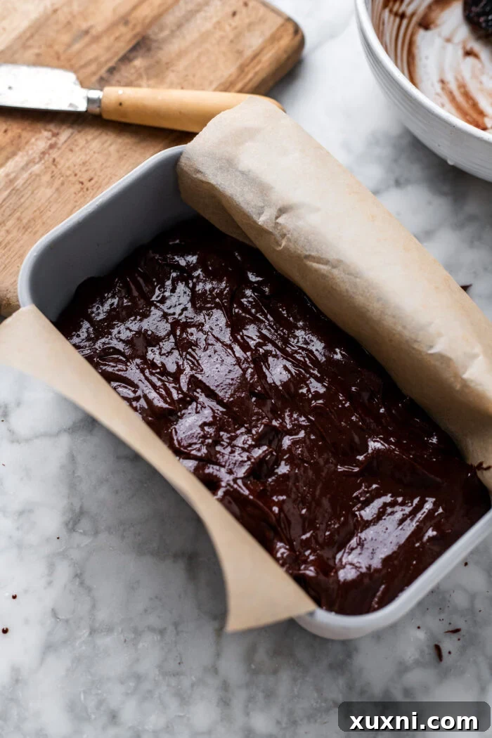 Vegan Small Batch Caramel Nut Brownies 12 Step 7: Brownie batter poured into a loaf pan, ready for baking