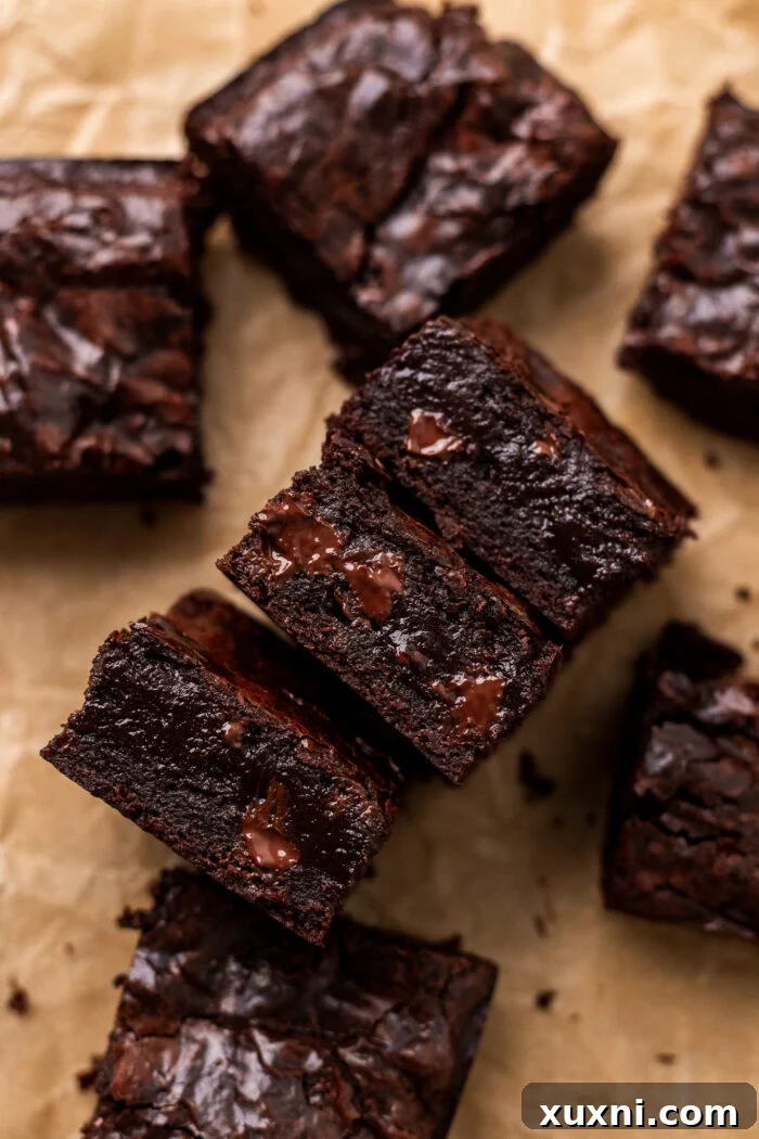 Vegan Small Batch Caramel Nut Brownies 16 Stack of freshly baked vegan brownies on parchment paper