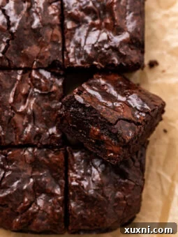 sliced vegan small batch brownies on parchment paper
