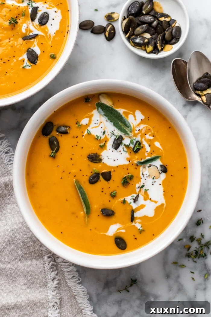 bowl of vegan sweet potato soup with pumpkin seeds