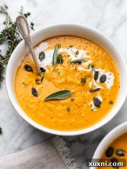 bowl of sweet potato soup with spoon in it