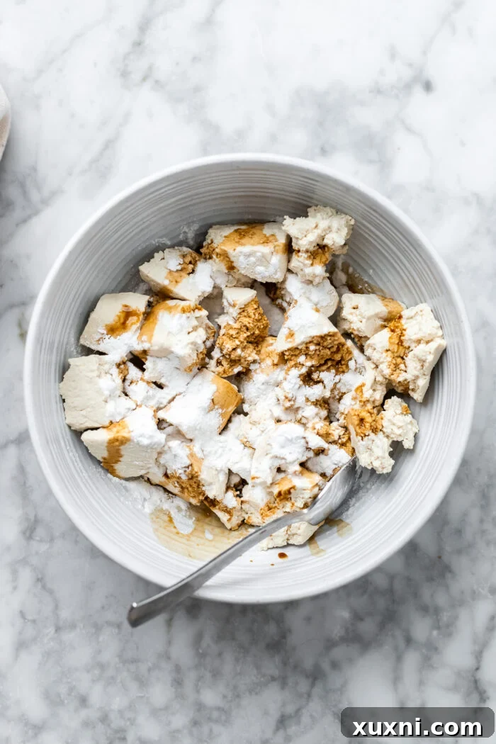 tofu with cornstarch and soy sauce in a bowl
