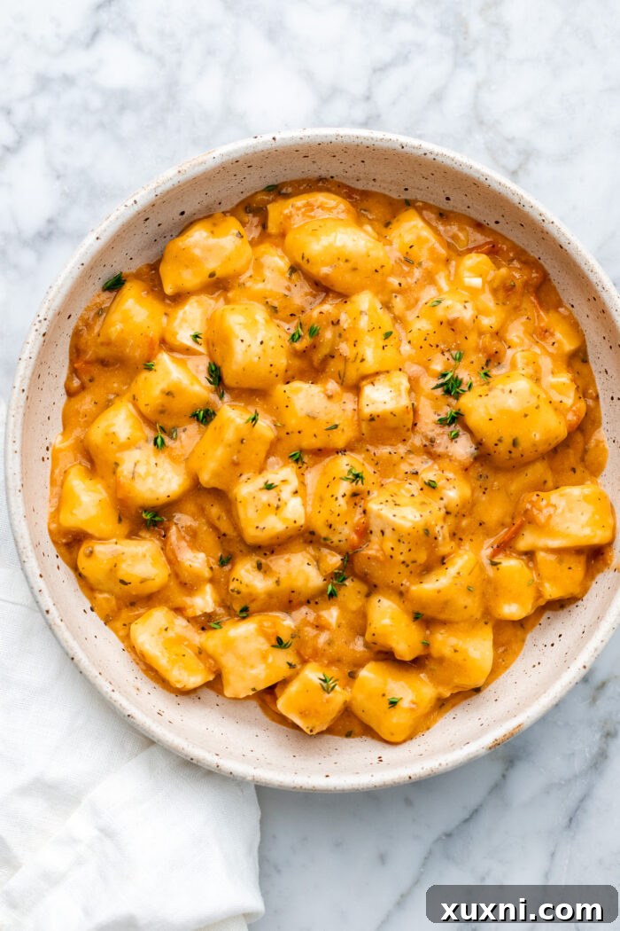 marry me tofu and gnocchi in a bowl with a cloth next to it, perfectly plated