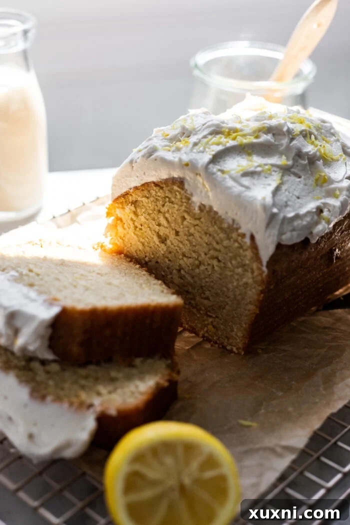Delightful slice of moist vegan lemon drizzle cake on a plate, ready to be enjoyed.