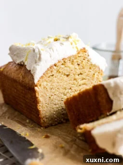 Beautifully baked and sliced vegan lemon loaf cake, ready to serve.