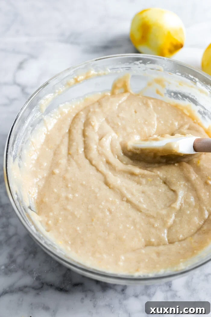 Smooth vegan lemon drizzle cake batter in a bowl, ready for baking.