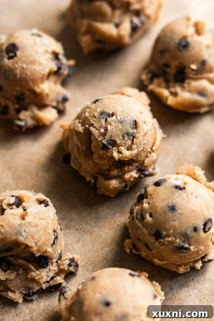 cookie dough scooped on parchment paper
