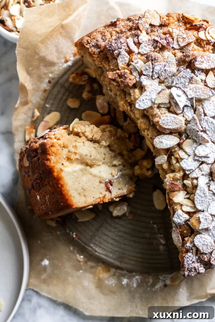An inviting slice of vegan almond coffee cake served on a dessert plate.