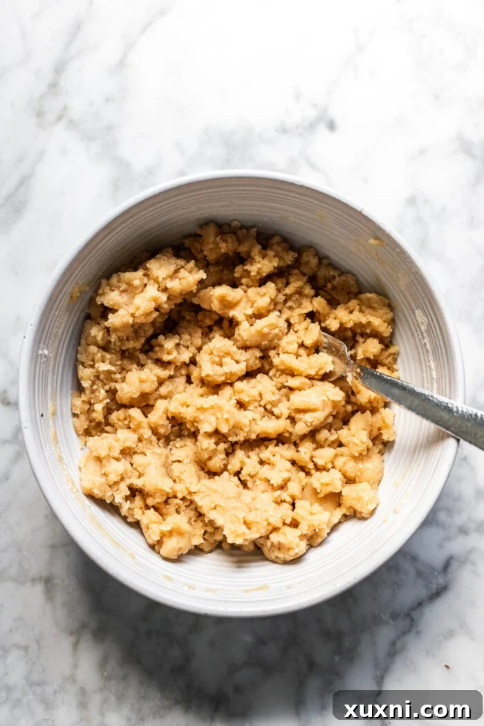 Vanilla crumb topping mixed in a bowl, showing a sandy texture.