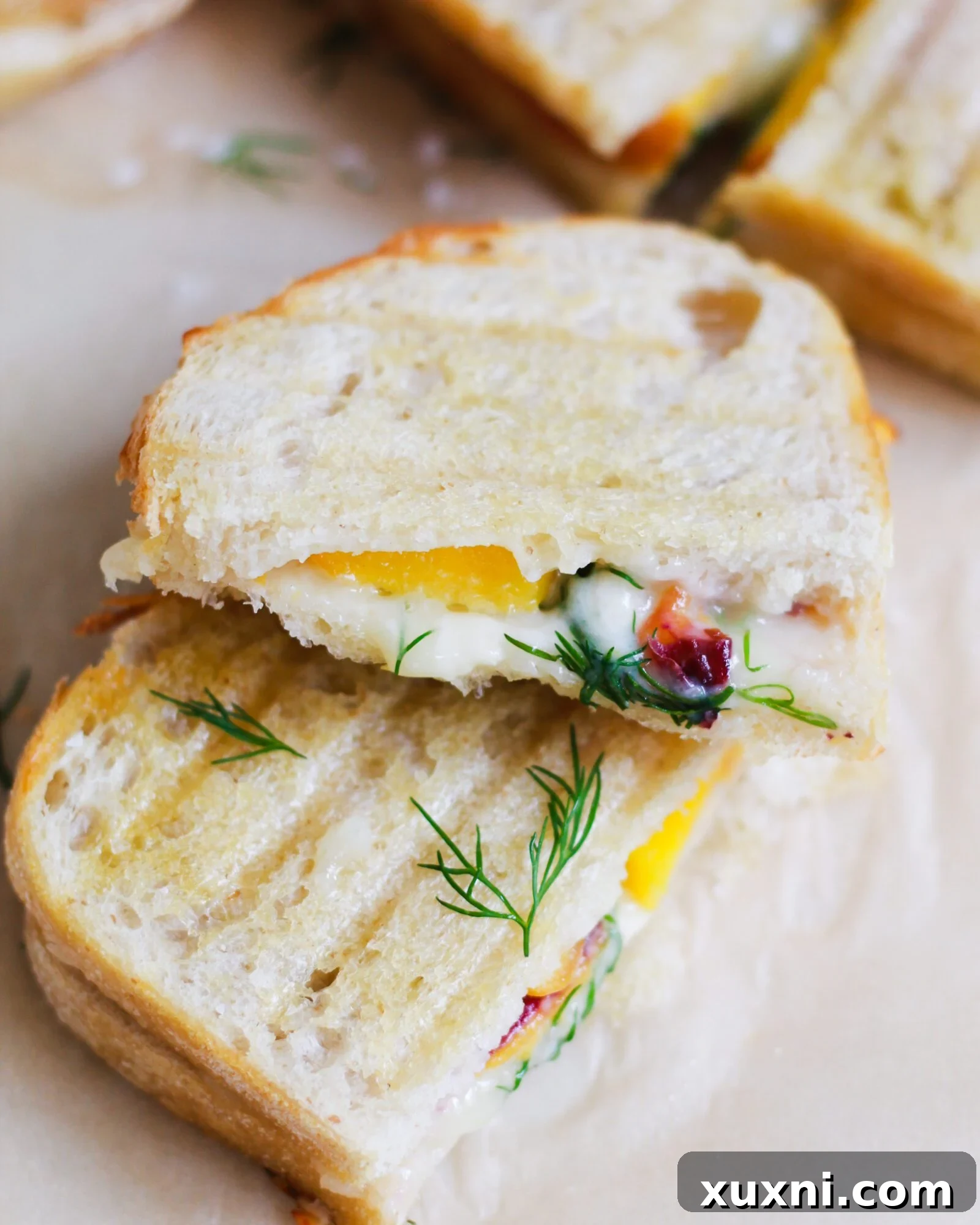 sliced healthy grilled cheese sandwich with peach and dill