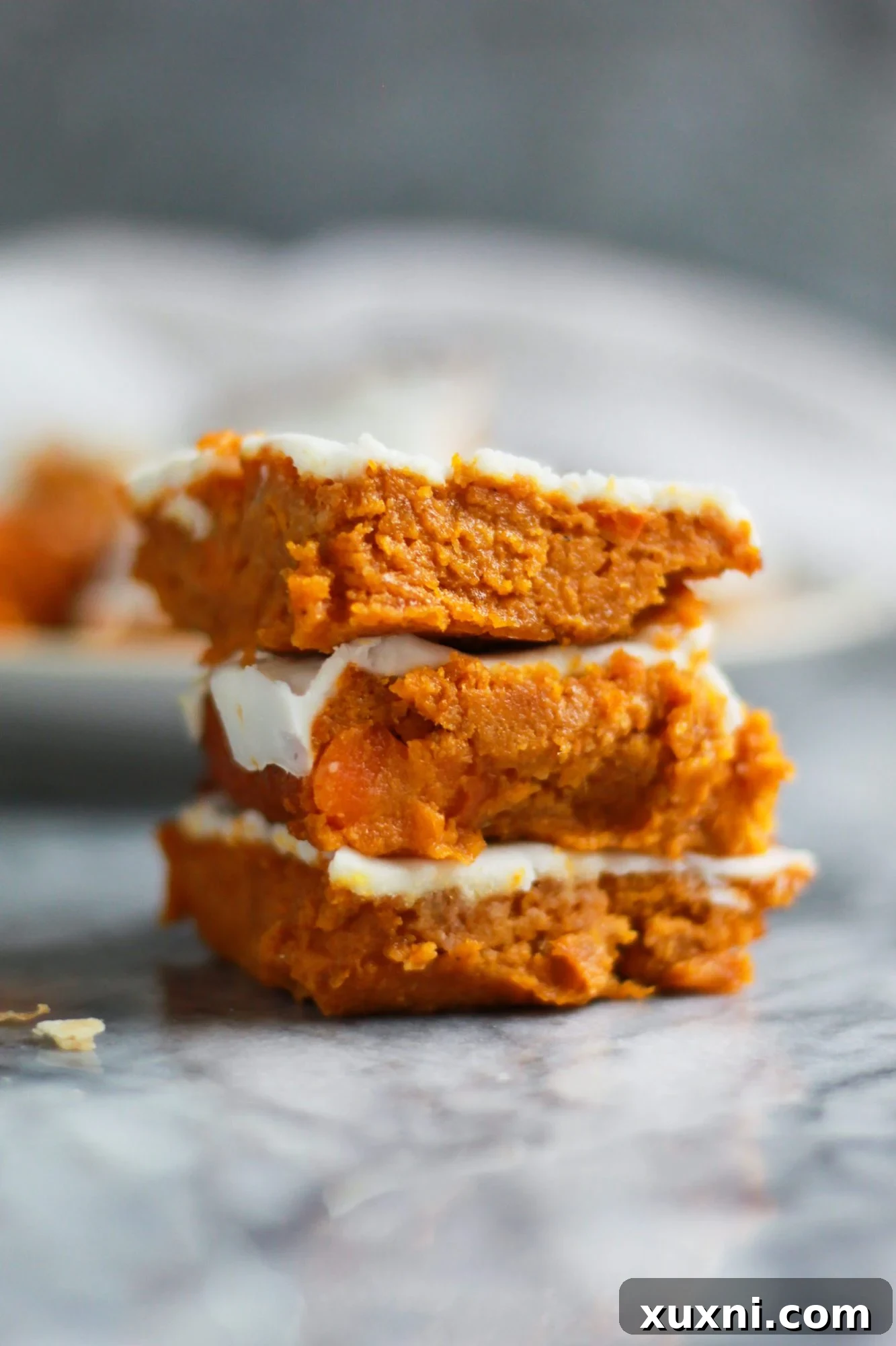 Stack of moist, paleo, vegan carrot cake bars ready to be enjoyed.