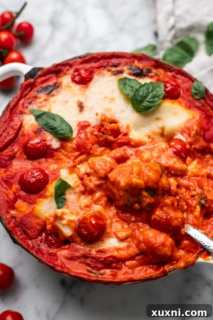 Baked gnocchi alla Sorrentina in a pot with tomato sauce and melted dairy-free mozzarella, garnished with fresh basil.
