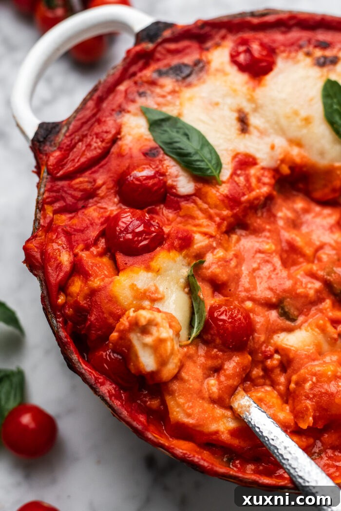 A full bowl of baked Gnocchi alla Sorrentina, steaming hot, with perfectly melted dairy-free mozzarella and fresh basil garnish.