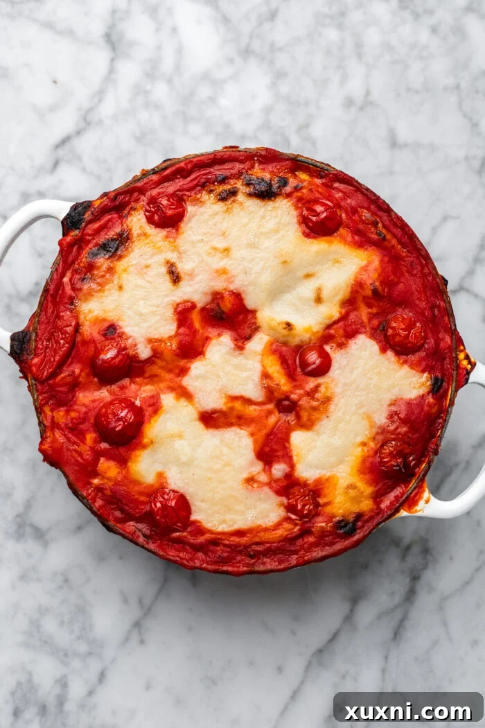 Layers of gnocchi in tomato sauce and dairy-free mozzarella assembled in a baking dish, ready to be baked.